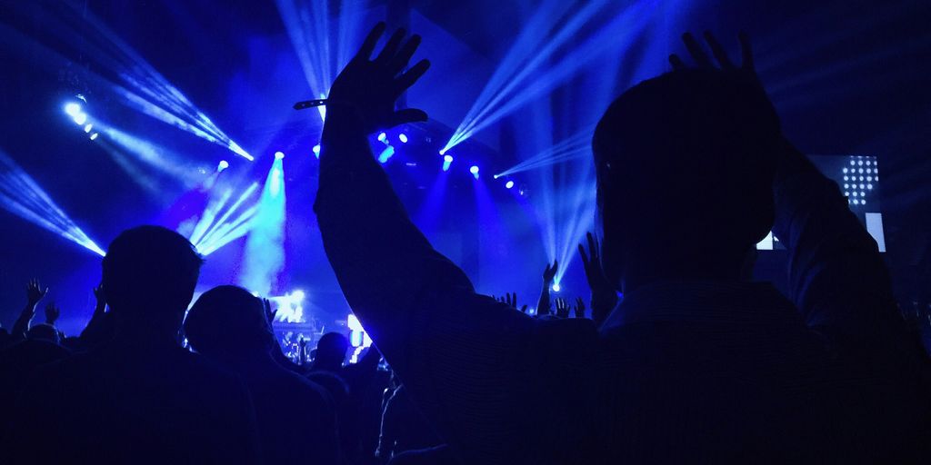 group of people standing inside dome watching concert